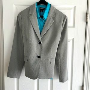 Professional suit jacket with lightweight sleeveless shirt underneath.